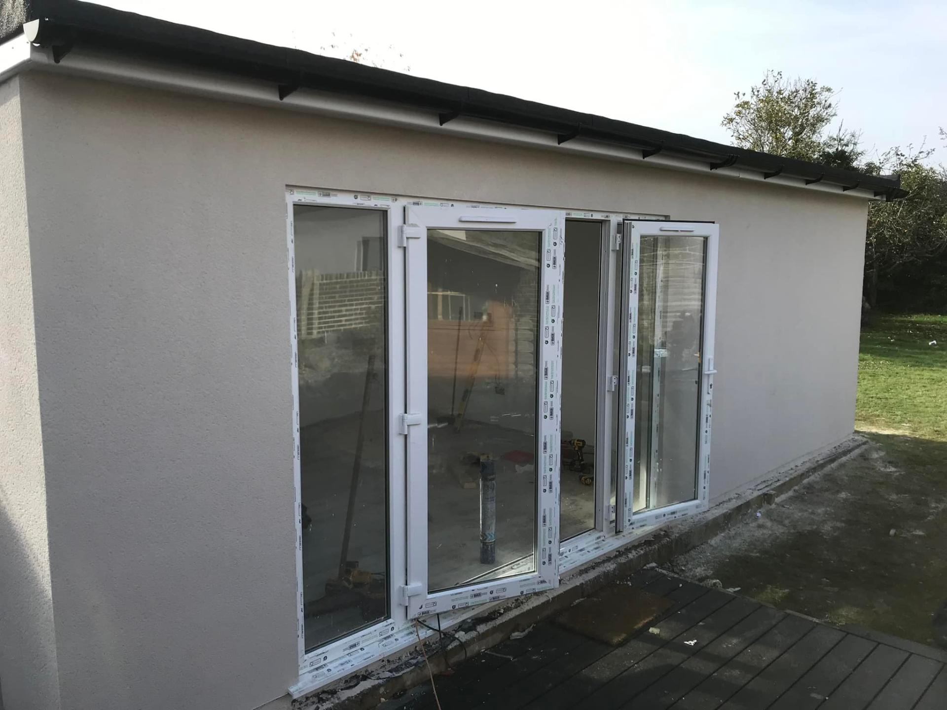 Extension with white bifold doors and rendered walls