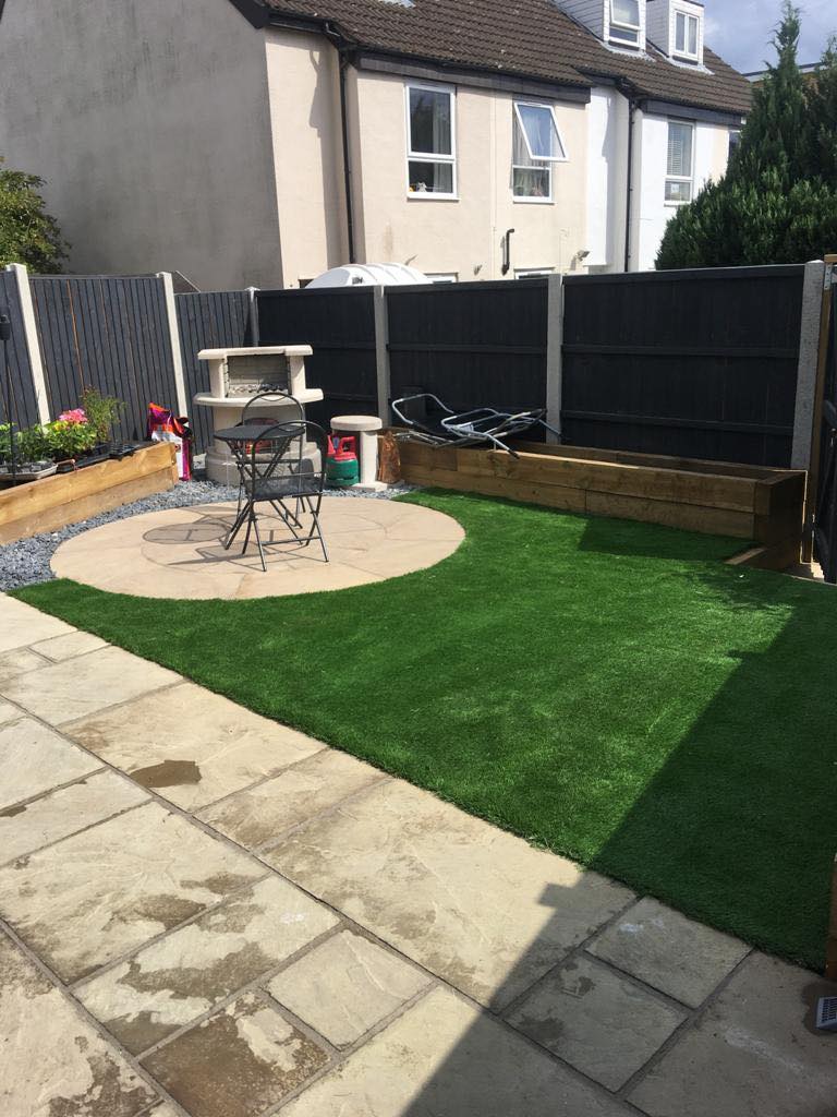 Landscaped garden with artificial lawn and paving