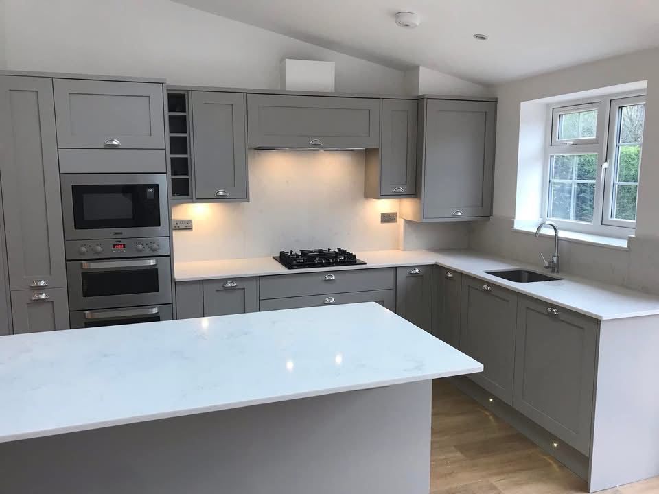 Grey shaker kitchen with white quartz worktops